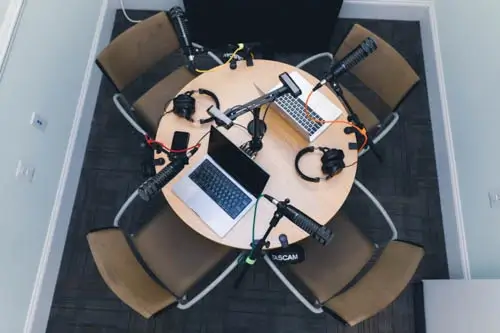 an overhead view of the recording room, outfitted with tables, chairs, and microphones